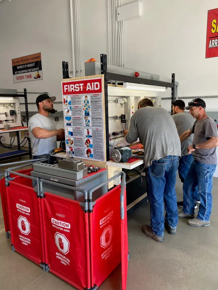 Students working through hands-on training with safety procedures posted nearby